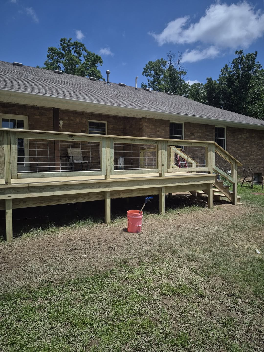 Completed raised deck with stairs and cable railing